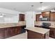 Kitchen with island and dark wood cabinets at 88 Norris Farm Dr, Angier, NC 27501