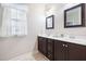 Bathroom with double vanity, large mirrors, and tile floor at 901 Townes Park St, Wake Forest, NC 27587