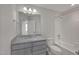 Clean and bright bathroom featuring a bathtub, single vanity, and modern fixtures at 1114 Blackthorne Rd, Durham, NC 27703