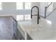 Kitchen island features a farmhouse sink and sleek black faucet at 1114 Blackthorne Rd, Durham, NC 27703