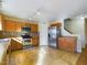 Kitchen with stainless steel appliances, tile floor, and wooden cabinets at 1309 Silver Dr, Mebane, NC 27302