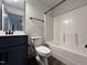 Clean bathroom with dark vanity, white toilet, and tub/shower combo at 136 S Mistflower St, Clayton, NC 27520