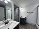 Modern bathroom with double vanity, dark cabinetry, and contemporary fixtures at 136 S Mistflower St, Clayton, NC 27520