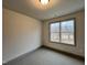 Well-lit bedroom with plush carpeting and a window showcasing a view at 136 S Mistflower St, Clayton, NC 27520