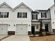 Charming two-story home with white siding, black trim, and attached garage at 136 S Mistflower St, Clayton, NC 27520