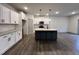 Bright, open kitchen featuring white cabinets, a contrasting island, and stainless steel appliances at 136 S Mistflower St, Clayton, NC 27520
