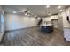 Open-concept living area adjacent to the kitchen, featuring wood-look flooring and a ceiling fan at 136 S Mistflower St, Clayton, NC 27520