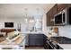 Modern kitchen with stainless steel appliances, white countertops, and dark wood cabinets at 1413 Hollyview Ave, Durham, NC 27703