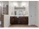 Double vanity bathroom with dark brown cabinets and a large mirror at 154 Alamosa Pl, Cary, NC 27519