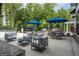 Community pool with grilling station, outdoor furniture, and mature trees at 1788 Farm Pond Trl, Durham, NC 27703