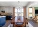 Dining area with a wooden table, chairs, and large windows overlooking the backyard at 1788 Farm Pond Trl, Durham, NC 27703