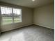 Bedroom with carpeted floors, a large window, and neutral-toned walls at 234 Starry Sky Dr, Benson, NC 27504