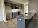 Kitchen with an island, granite counters, subway tile backsplash, dark gray cabinets, and stainless steel appliances at 234 Starry Sky Dr, Benson, NC 27504