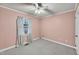 Vacant bedroom with pink walls, ceiling fan, and carpeted flooring at 2416 Wilkins St, Burlington, NC 27217