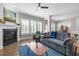 Spacious living room with a fireplace, plantation shutters, and access to the dining area at 247 Old Piedmont Cir, Chapel Hill, NC 27516