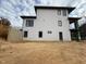 Side view of a three-story modern house with white siding and multiple windows at 409 Waldo St, Cary, NC 27511