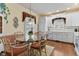 Kitchen with white cabinets, breakfast table, and hardwood floors at 421 Weathergreen Dr, Raleigh, NC 27615