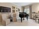 Living room with grand piano, large TV, and elegant decor at 421 Weathergreen Dr, Raleigh, NC 27615