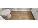 Partial view of bathroom with toilet and wood-look flooring at 5038 Flint Ridge Pl, Raleigh, NC 27609