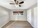Spacious bedroom with wood-look flooring, ceiling fan, and ample natural light at 5038 Flint Ridge Pl, Raleigh, NC 27609