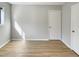 Bright bedroom with wood-look flooring and neutral gray walls at 5038 Flint Ridge Pl, Raleigh, NC 27609