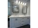 Double vanity bathroom with illuminated mirrors at 601 Vannoy Pl, Fuquay Varina, NC 27526