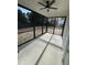 Relaxing screened porch with ceiling fan and concrete flooring at 601 Vannoy Pl, Fuquay Varina, NC 27526