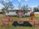 Quaint home with covered porch, fire pit, and seating area at 670 Mcadams Rd, Hillsborough, NC 27278