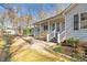 A view of the home's front porch and white railing, nestled in a natural setting at 713 Cooke Rd, Louisburg, NC 27549