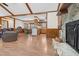 Open concept living area with fireplace, exposed beams, and view of the kitchen at 713 Cooke Rd, Louisburg, NC 27549