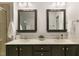 Double vanity bathroom with dark wood cabinets, mirrors, and neutral countertops at 717 Grace Hodge Dr, Cary, NC 27519