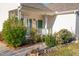 Front entrance with a small covered porch, green shutters, and landscaped shrubs at 8325 Neuse Grove Ln, Raleigh, NC 27616