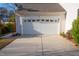 Attached two-car garage with a white door and decorative window panels at 8325 Neuse Grove Ln, Raleigh, NC 27616