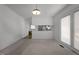 Dining room with carpeted floors, a hanging light fixture, and an adjacent kitchen at 920 Essex Dr, Graham, NC 27253