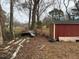 Backyard view with a red shed and scattered debris at 923 Sunny Ln, Raleigh, NC 27603