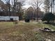 Spacious grassy yard with mobile homes, mature trees, and parked cars at 923 Sunny Ln, Raleigh, NC 27603