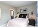 Modern bedroom with stylish decor, including a unique headboard and wall sconces at 9520 Wood River Dr, Zebulon, NC 27597