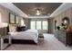 Large Primary bedroom with plush carpeting, tray ceiling, and ample natural light at 9520 Wood River Dr, Zebulon, NC 27597