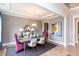 Formal dining room with pink chairs and a large circular light fixture at 9520 Woodriver Dr, Zebulon, NC 27597