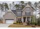 Charming two-story home with a welcoming front porch and a brick and siding exterior at 9520 Wood River Dr, Zebulon, NC 27597