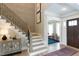 Grand foyer with a staircase, hardwood floors, and access to adjacent rooms at 9520 Wood River Dr, Zebulon, NC 27597
