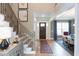 Inviting foyer with a staircase, area rug, and views of the adjacent dining area at 9520 Wood River Dr, Zebulon, NC 27597