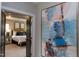 Inviting hallway leading to a bedroom with an eye-catching painting at 9520 Wood River Dr, Zebulon, NC 27597