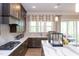 Modern kitchen with ample counter space, gas range, and access to outdoor living at 9520 Wood River Dr, Zebulon, NC 27597