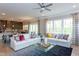 Spacious open-concept living area with comfortable sofas, large windows, and kitchen access at 9520 Wood River Dr, Zebulon, NC 27597