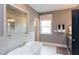 Modern main bathroom with a soaking tub, glass shower, and double vanity at 9520 Wood River Dr, Zebulon, NC 27597