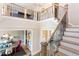 Elegant staircase with decorative railing overlooking dining area at 9520 Wood River Dr, Zebulon, NC 27597
