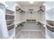 Spacious walk-in closet with built-in shelves, hanging rods, and ample storage space at 9520 Wood River Dr, Zebulon, NC 27597