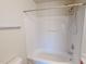 Bathroom with bathtub/shower combo and white tile surround at 100 Stratford Lakes Dr # 318, Durham, NC 27713