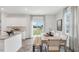 Open-concept kitchen and dining area with white cabinets, granite countertops, and sliding glass doors at 107 Ethel Ln, Angier, NC 27501